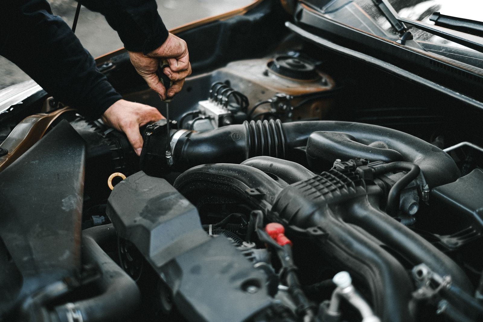 Photo – mechanic working on a car engine