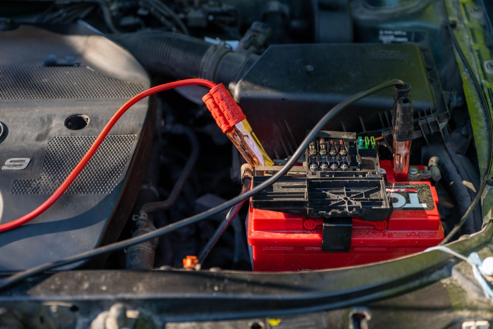 Photo – jumper cables connected to a car battery